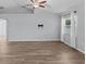 Bright living room featuring wood-look tile floors and a ceiling fan at 708 Tower Grove Dr, Plant City, FL 33567