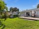 Large backyard with grassy lawn and patio at 709 Mandalay Ave, Clearwater Beach, FL 33767