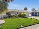 Single story home with lush green lawn and palm trees at 709 Mandalay Ave, Clearwater Beach, FL 33767