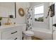 Modern bathroom with white vanity, marble bathtub, and gold fixtures at 4501 21St N St, St Petersburg, FL 33714