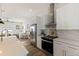 Modern kitchen with white cabinets, stainless steel appliances, and gold fixtures at 4501 21St N St, St Petersburg, FL 33714