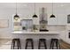 Modern kitchen with white cabinets, a large island, and gold accents at 4501 21St N St, St Petersburg, FL 33714