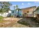 Backyard view featuring a small, light blue house at 8416 N Semmes St, Tampa, FL 33604