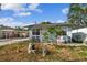 Light blue house with carport and small front yard at 8416 N Semmes St, Tampa, FL 33604