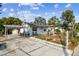 Light blue house with carport and fenced yard at 8416 N Semmes St, Tampa, FL 33604