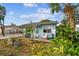 Cute light blue house with mature landscaping at 8416 N Semmes St, Tampa, FL 33604