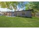 Newly renovated gray house with covered patio and large yard at 10206 Lola St, Tampa, FL 33612