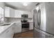 Modern white kitchen with stainless steel appliances at 10206 Lola St, Tampa, FL 33612