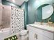 Bathroom with teal walls, white vanity, and bathtub at 12969 Brookside Moss Dr, Riverview, FL 33579