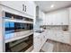 Stainless steel appliances and white shaker cabinets in kitchen at 12969 Brookside Moss Dr, Riverview, FL 33579