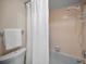 Simple bathroom with shower, toilet and a white curtain at 1669 Fry Ct, Dunedin, FL 34698