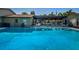 Community pool with covered patio and seating at 1669 Fry Ct, Dunedin, FL 34698
