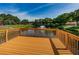Wooden dock overlooking a pond with a fountain at 1669 Fry Ct, Dunedin, FL 34698