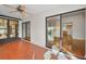 Sunroom with access to the kitchen and hardwood floors at 1669 Fry Ct, Dunedin, FL 34698