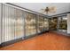 Sunroom with tile floors and ceiling fan at 1669 Fry Ct, Dunedin, FL 34698