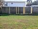 Grassy backyard featuring a wooden fence with newly replaced planks at 37500 Laurel Hammock Dr, Zephyrhills, FL 33541