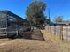 Backyard with wooden fence and sparse grass at 39219 5Th Ave, Zephyrhills, FL 33542