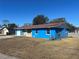 Blue Ranch home with stone accents, two-car garage, and fenced backyard at 39219 5Th Ave, Zephyrhills, FL 33542