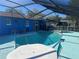 Inviting pool and spa with screened patio and table at 39219 5Th Ave, Zephyrhills, FL 33542