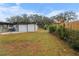 Large backyard with a detached garage and wooden fence at 6602 S Emerson Ave, St Petersburg, FL 33707