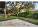 Landscaped backyard with spacious patio and mature oak trees at 6602 S Emerson Ave, St Petersburg, FL 33707