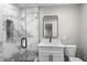 Clean bathroom with marble shower, white vanity, and toilet at 6602 S Emerson Ave, St Petersburg, FL 33707