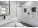 Modern bathroom with marble shower, hexagon floor tiles, and white vanity at 6602 S Emerson Ave, St Petersburg, FL 33707