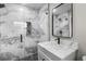 Updated bathroom, featuring a white vanity and marble shower at 6602 S Emerson Ave, St Petersburg, FL 33707
