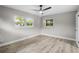 Spacious bedroom with ceiling fan, light grey walls, and wood-look flooring at 6602 S Emerson Ave, St Petersburg, FL 33707