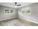 Bright bedroom with ceiling fan, neutral walls, and wood-look flooring at 6602 S Emerson Ave, St Petersburg, FL 33707