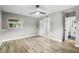 Bright bedroom with wood-look floors and ceiling fan at 6602 S Emerson Ave, St Petersburg, FL 33707