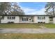 Updated ranch home with fresh paint, modern entryway, and carport at 6602 S Emerson Ave, St Petersburg, FL 33707