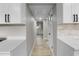 Clean and bright hallway with light grey walls and wood-look flooring at 6602 S Emerson Ave, St Petersburg, FL 33707