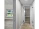 Light hallway with wood-look floors and neutral walls at 6602 S Emerson Ave, St Petersburg, FL 33707