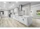 Open concept kitchen featuring white cabinets, large island, and luxury vinyl flooring at 6602 S Emerson Ave, St Petersburg, FL 33707
