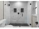 Large walk-in shower with marble tile and black accents at 6602 S Emerson Ave, St Petersburg, FL 33707