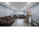 Living room with brown leather furniture at 1009 Black Knight Dr, Valrico, FL 33594
