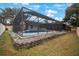 Enclosed pool area with stone wall and fenced yard at 1009 Black Knight Dr, Valrico, FL 33594