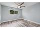 Spacious bedroom with wood-look floors and ceiling fan at 1179 Huntington Ave, Spring Hill, FL 34609