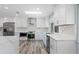 Modern kitchen featuring white cabinets and stainless steel appliances at 1179 Huntington Ave, Spring Hill, FL 34609