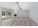 Spacious living room featuring a stone fireplace and sliding doors leading to the backyard at 1179 Huntington Ave, Spring Hill, FL 34609