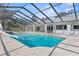 Inviting screened pool with spa and slide; perfect for relaxation at 1179 Huntington Ave, Spring Hill, FL 34609