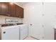 Laundry room with Whirlpool washer and dryer, and cabinets at 19494 Sea Glass Cir, Land O Lakes, FL 34638