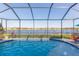 Enjoy this refreshing pool with a lake view from under the screened enclosure at 19494 Sea Glass Cir, Land O Lakes, FL 34638