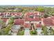 Aerial image of community featuring multiple homes with red tile roofs and lush landscaping at 3076 Braeloch E Cir # 5, Clearwater, FL 33761
