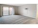 Bedroom with plush carpeting and sliding door to balcony at 3076 Braeloch E Cir # 5, Clearwater, FL 33761