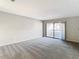 Spacious bedroom with balcony access and grey carpet at 3076 Braeloch E Cir # 5, Clearwater, FL 33761