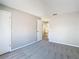 Bright bedroom with grey carpet and access to another room at 3076 Braeloch E Cir # 5, Clearwater, FL 33761