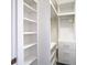 Spacious walk-in closet with built-in shelves and hanging rods at 3076 Braeloch E Cir # 5, Clearwater, FL 33761