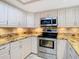 Updated kitchen with granite countertops and stainless steel appliances at 3076 Braeloch E Cir # 5, Clearwater, FL 33761